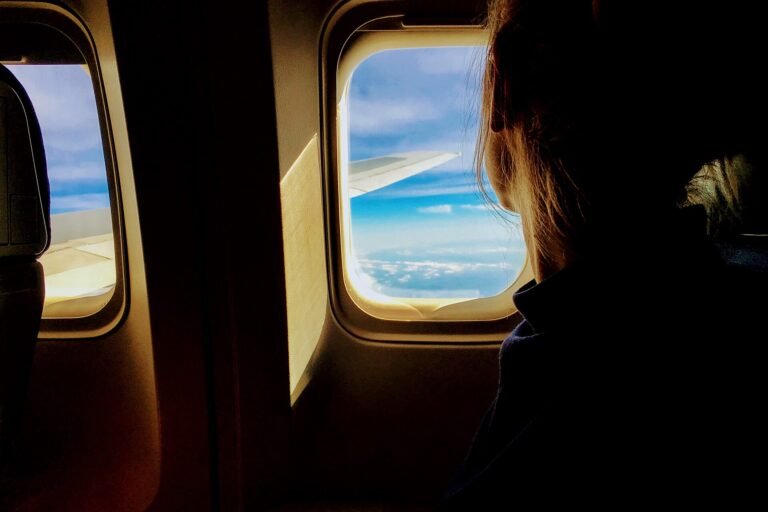 Bright sky and clouds seen from the window of a long-haul flight