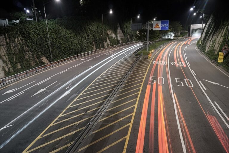 Light trails from luxury cars on a city expressway at night