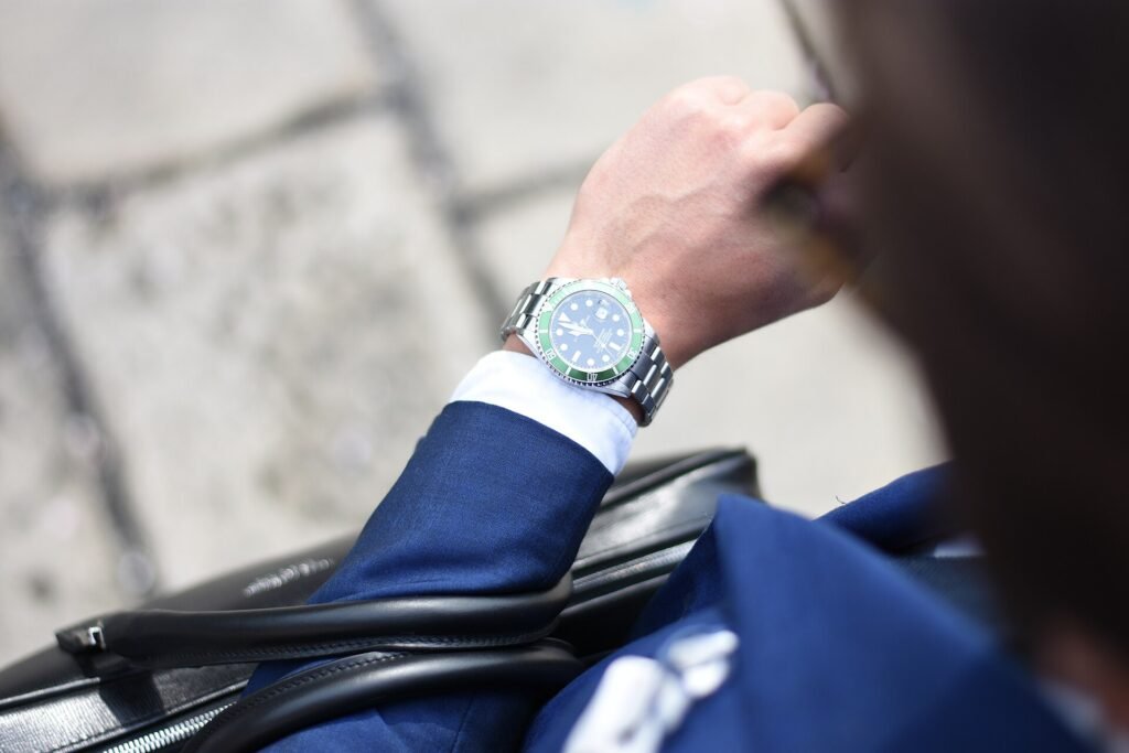 Man in a tailored suit glancing at his wristwatch