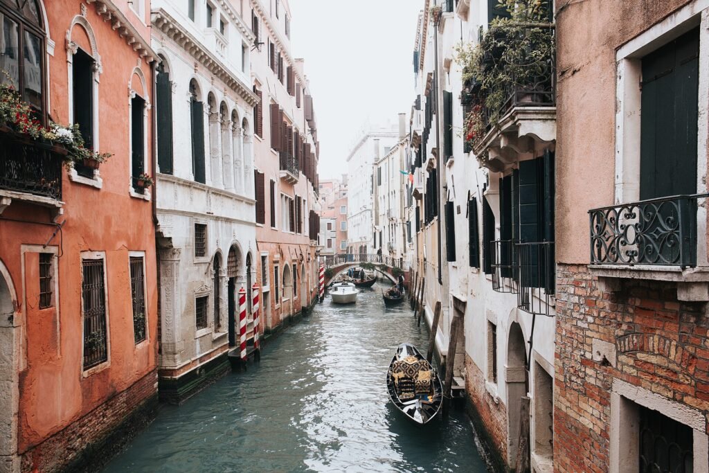 Narrow canal in Venice lined with colourful houses