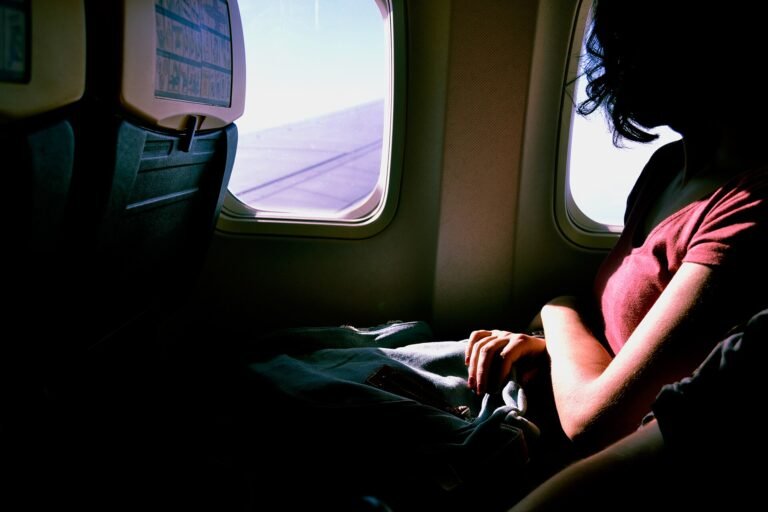 Passenger gazing out of an aircraft window in a premium long-haul cabin