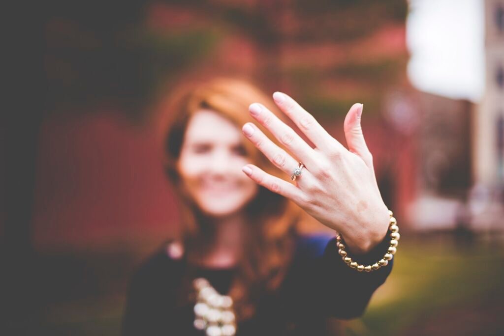 Smiling woman showing her diamond engagement ring