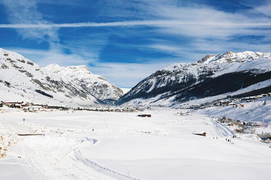 Snowy alpine valley with mountains rising above a quiet village