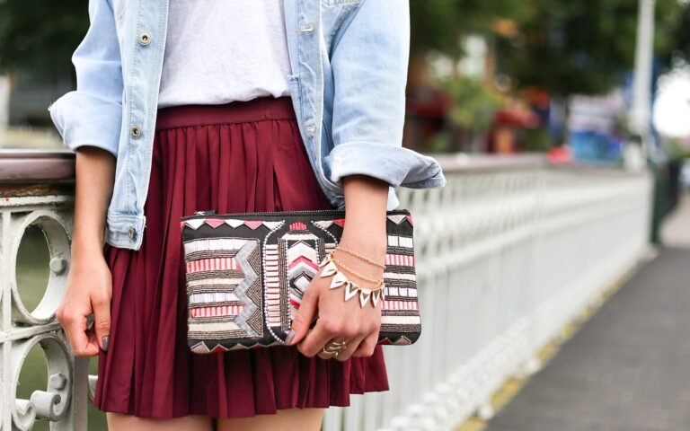 Stylish woman with a jewelled clutch and bracelet on a city street