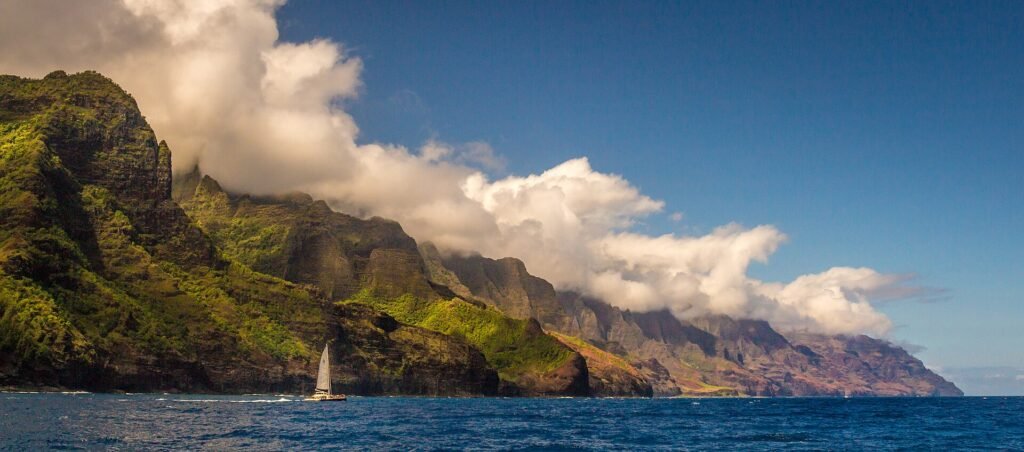 The fluted green cliffs of the Na Pali Coast dropping into the Pacific on Kauai