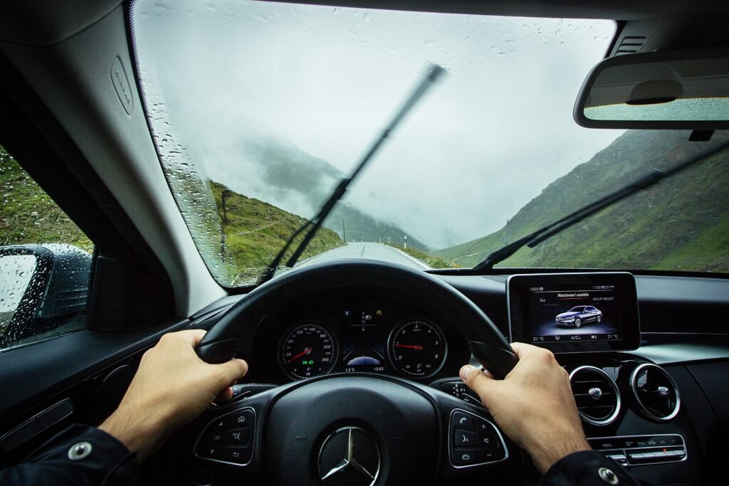 View from the driver’s seat of a Mercedes on a mountain road in the rain