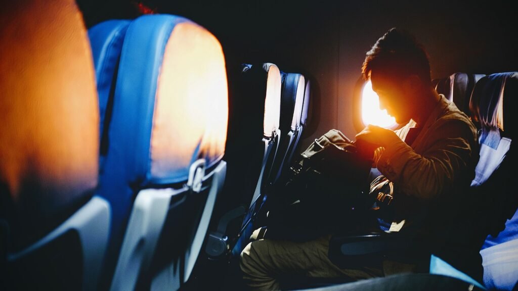 Warm evening light through an aircraft window inside a long-haul cabin